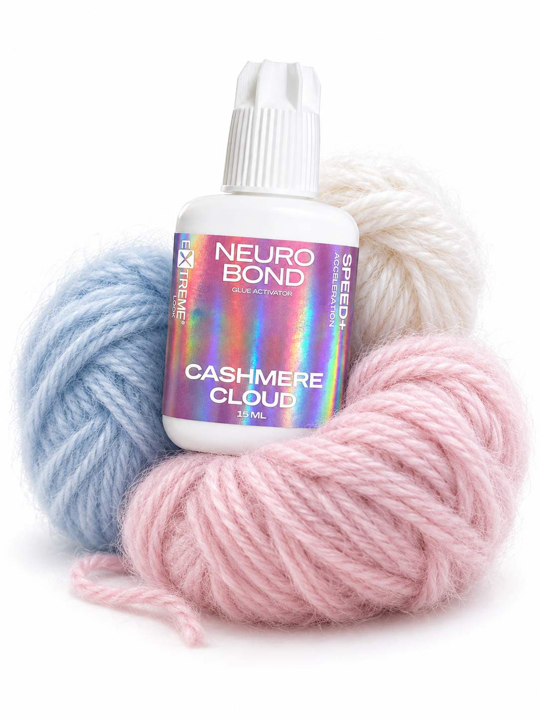 Flacone di acceleratore Extreme Look Neuro Bond adagiato su soffici gomitoli di lana pastello rosa, azzurra e bianca. Un richiamo visivo alla morbidezza del "cashmere", che rappresenta il controllo delicato ma potente del prodotto sulla polimerizzazione.