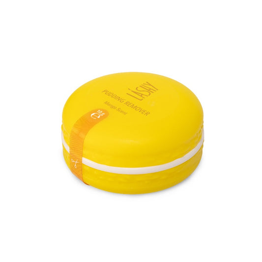 Barattolo chiuso a forma di macaron giallo brillante contenente il Pudding Remover LASHY al profumo di Mango. L'alleato professionale ideale per ottimizzare i tempi di lavoro e garantire comfort in cabina.